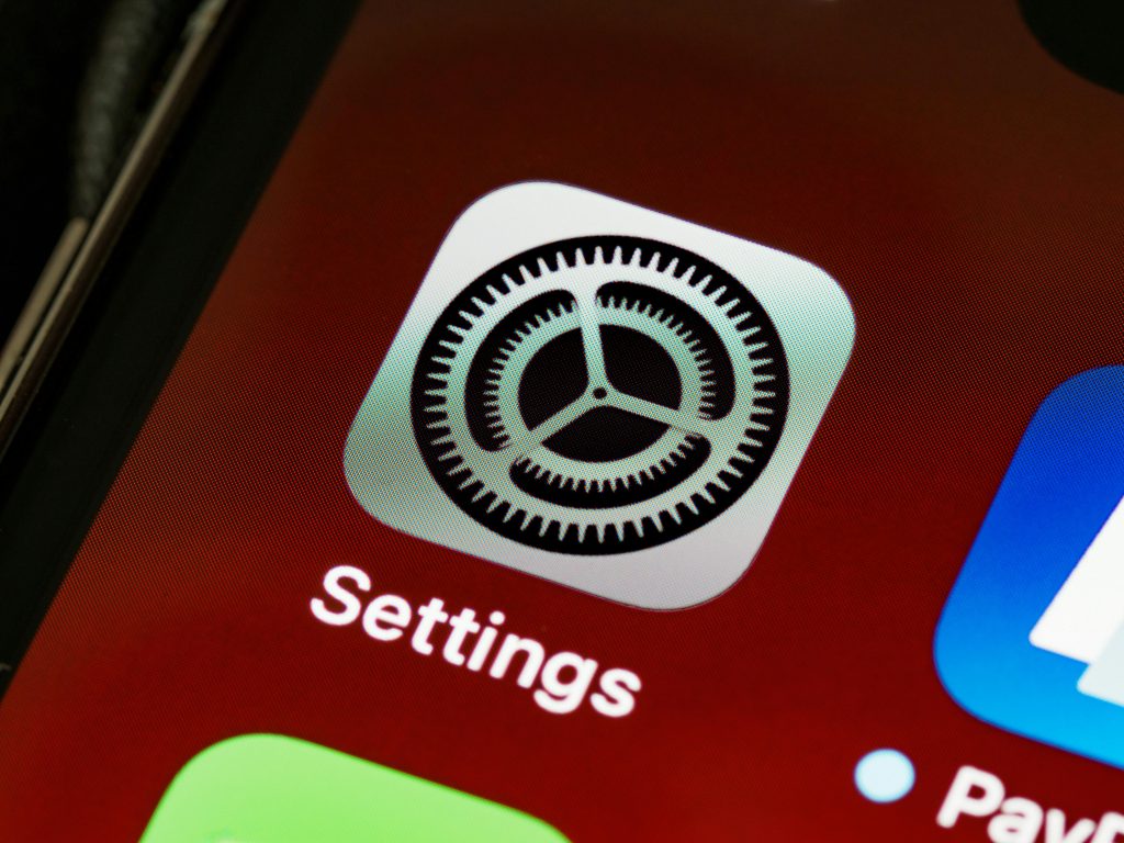 The iPhone Settings app icon on a phone screen, representing privacy controls